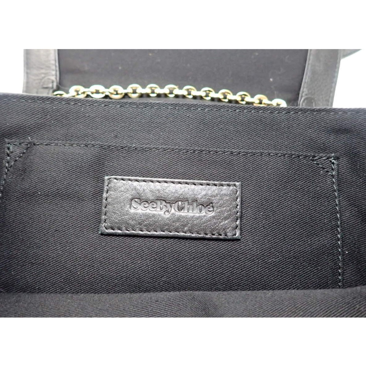 See by Chloé – Bolso bandolera de piel negra con cadena dorada y solapa